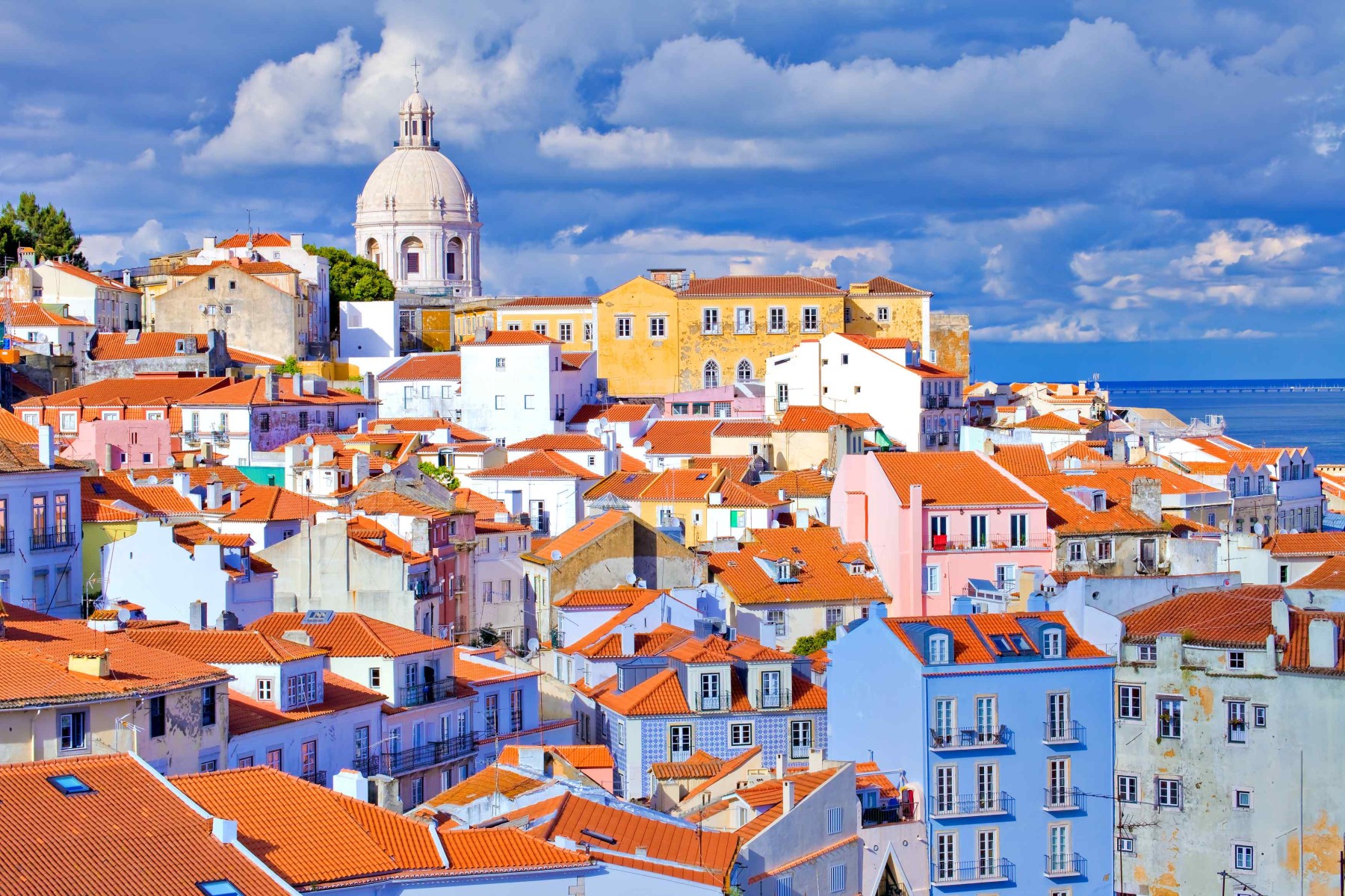 The historic and colorful Alfama district in Lisbon, Portugal. April provides the perfect mild weather for exploring these steep, winding streets.